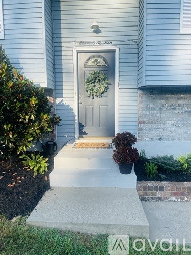 A grey door with a wreath on it.