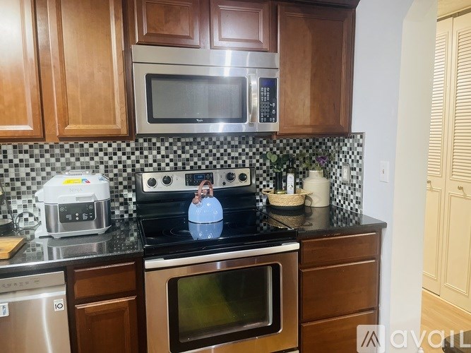 A kitchen with a black and white checkered backsplash.