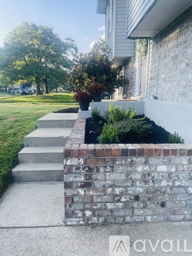 A brick wall with a planter box on top of it.