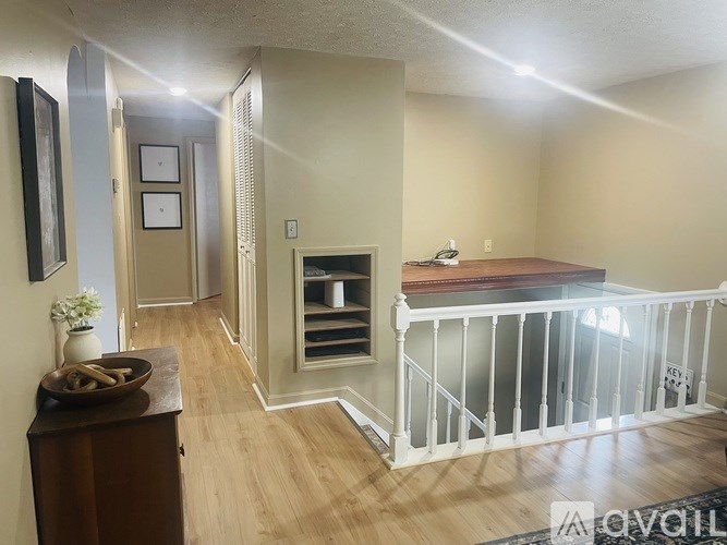 A living room with a fireplace and a balcony.