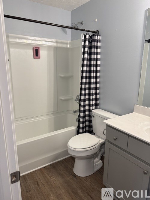A bathroom with a toilet, sink, and shower.