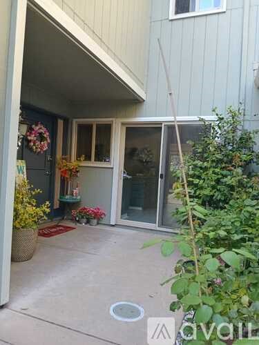 A patio area with a door and a wreath on the door.