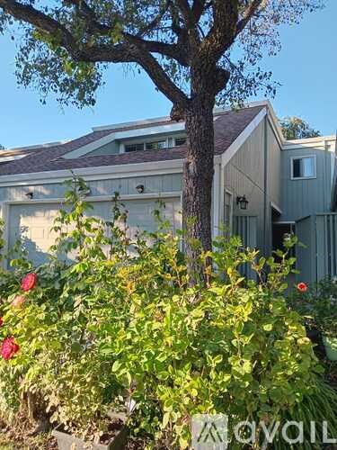 A house with a tree in front of it.