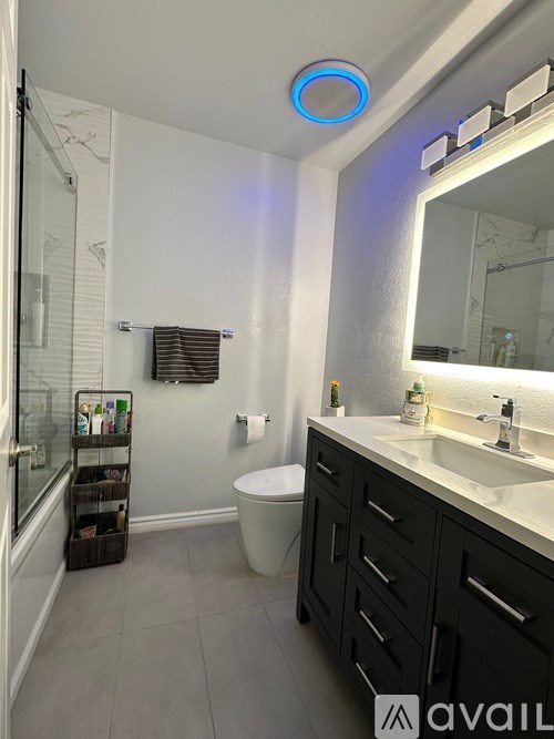 A building with a balcony and a tree in front.