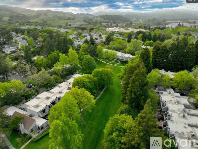 A bird's eye view of a residential area with houses and greenery.