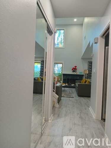 A living room with a fireplace and a mirror on the wall.