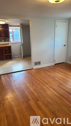 A room with wooden floors and a white door.