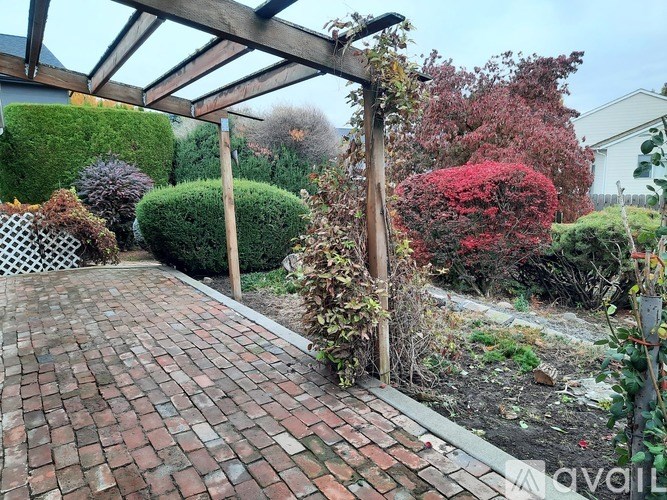 A room with three windows and carpeted floor.