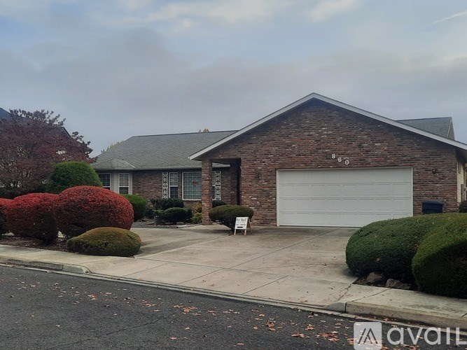 A house with a white garage door is for sale.
