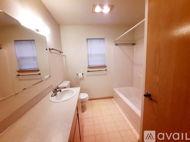 A bathroom with a sink, toilet, and bathtub.