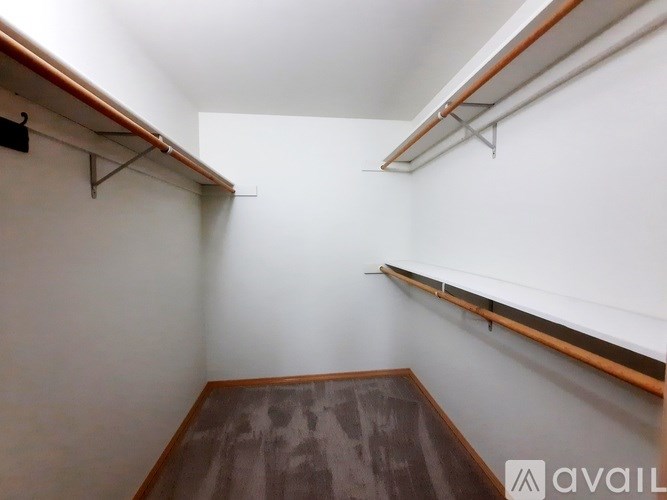 A garden with a brick pathway and a wooden pergola.