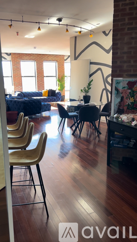 A room with wooden floors and a large painting on the wall.