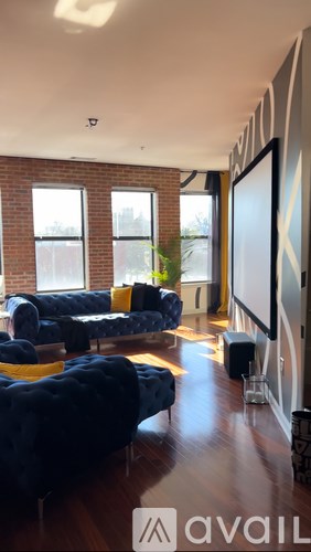 A living room with a blue couch and a television.