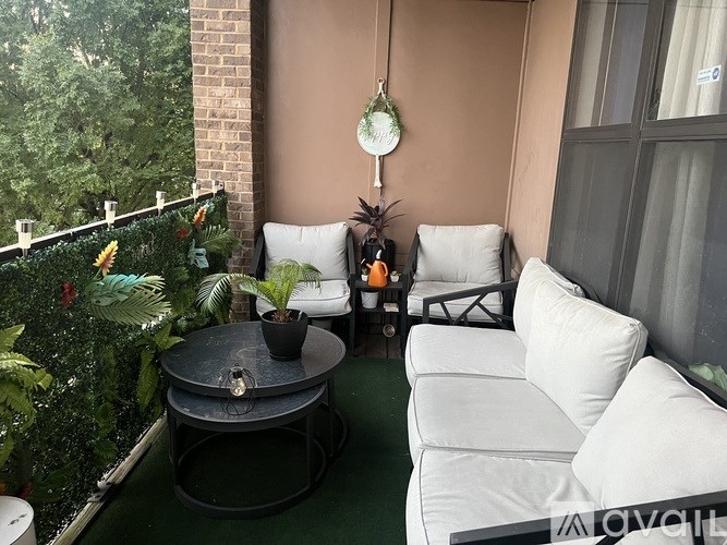 A small balcony with a table and chairs.