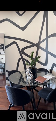 A glass table with a vase and a book on it.