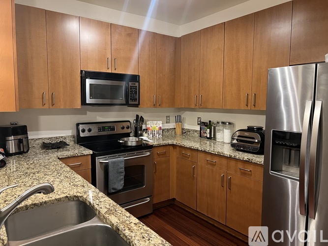 A kitchen with wooden cabinets and stainless steel appliances.
