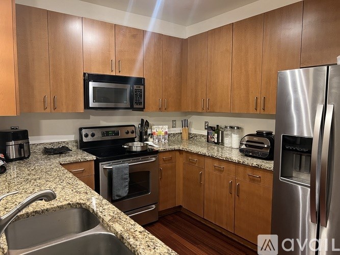 A kitchen with wooden cabinets and stainless steel appliances.
