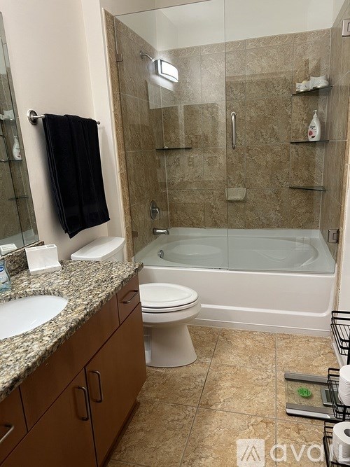 A bathroom with a toilet, sink, and bathtub.
