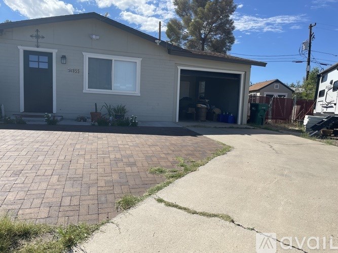 A house with a garage and driveway in front.