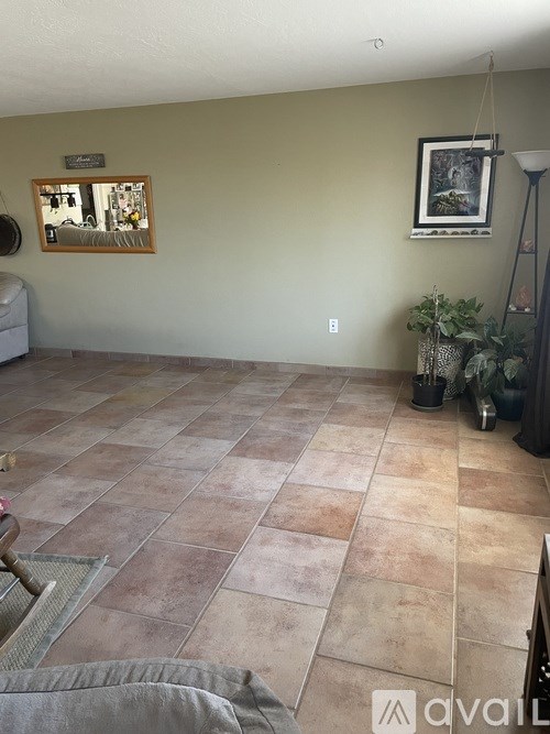 A room with a tiled floor and a picture frame on the wall.