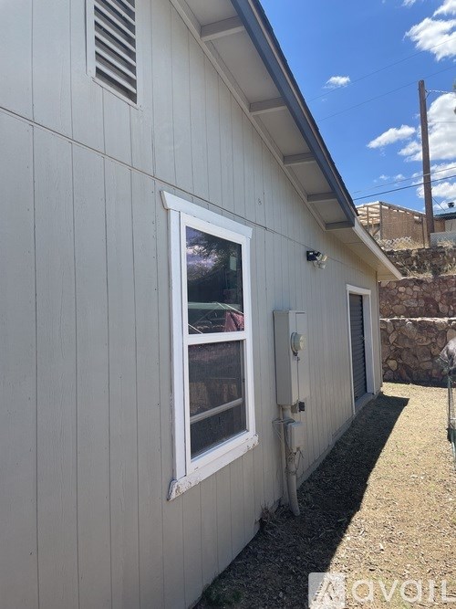 A white house with a window and a door.
