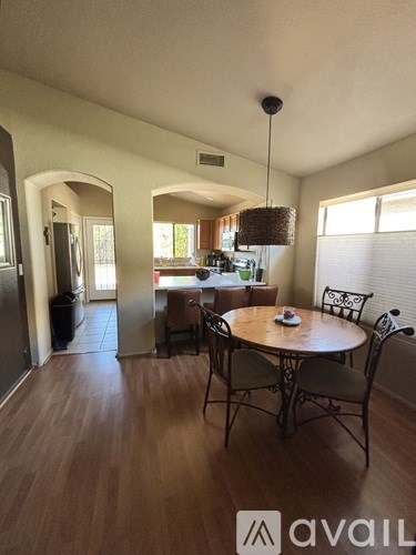 A dining room with a round table and chairs.