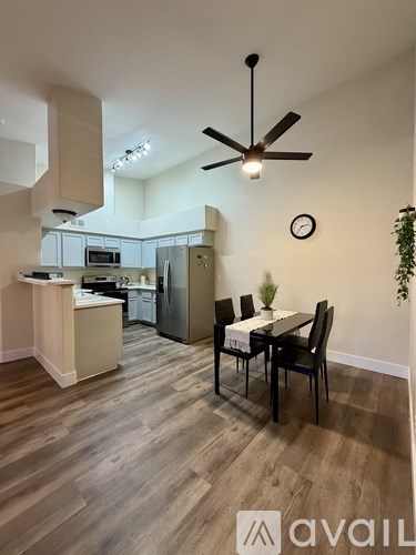 A kitchen with a table and chairs in the middle of the room.