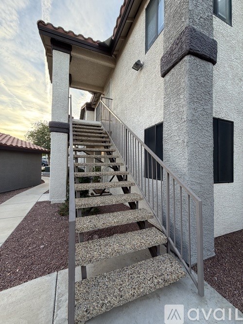 A house with a staircase leading to the front door.