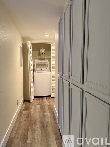 A kitchen with white appliances and cabinets is shown.