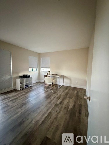 A room with wooden floors and white walls.
