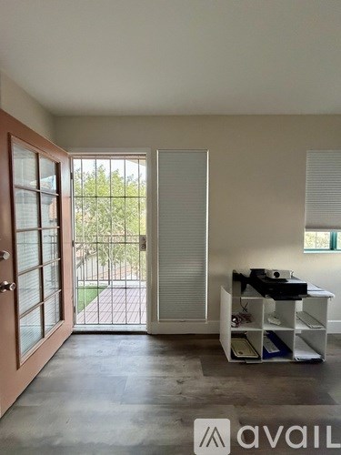 A room with a sliding door and a desk with a computer.