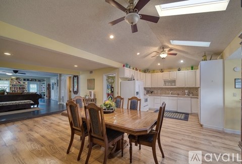 A dining room with a wooden table and chairs.