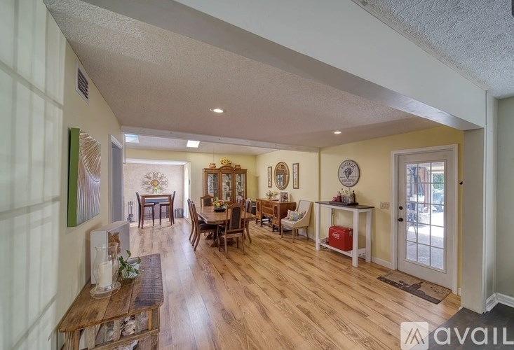 A living room with a wooden floor and furniture.