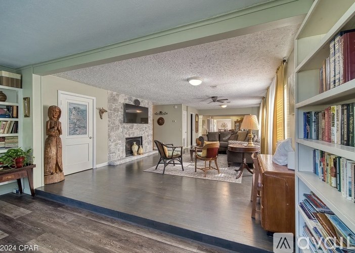 A living room with a fireplace and a bookshelf.