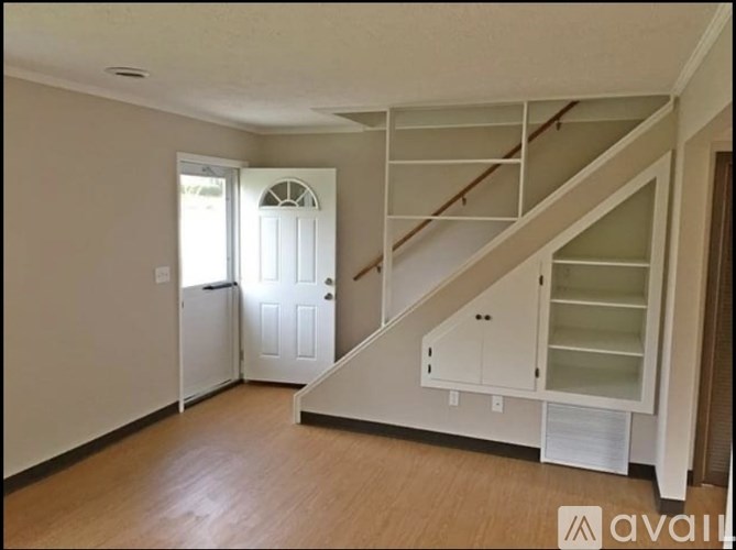A room with a staircase and a door.