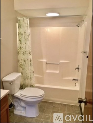 A white toilet and sink in a bathroom.