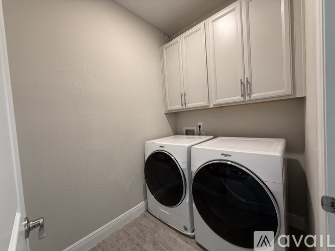 A laundry room with two front loading washing machines.