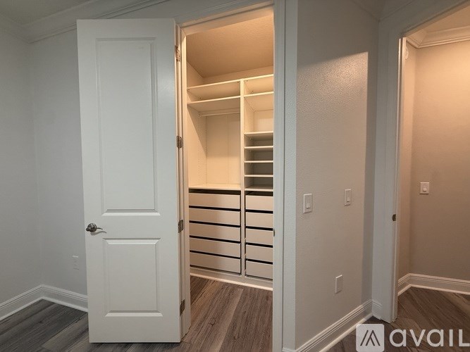 A white door is open to a room with a staircase.