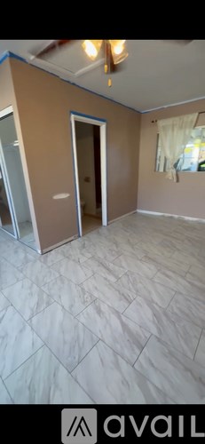 A room with a wooden floor and a white ceiling.