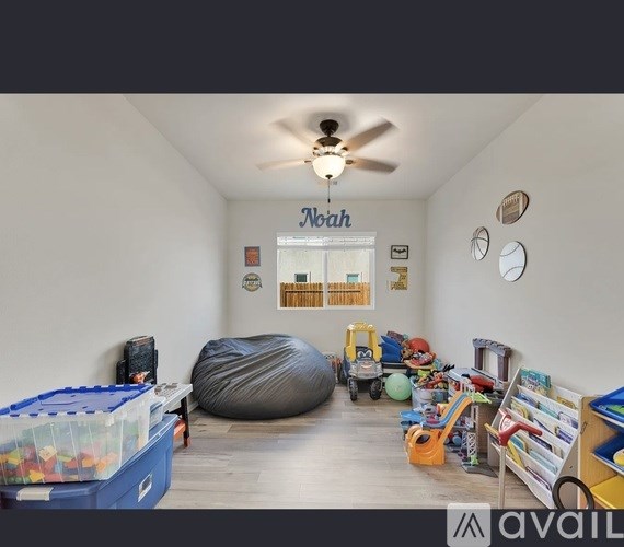 A room with a ceiling fan and a bean bag chair.