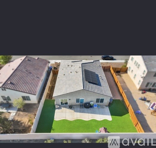 A house with a solar panel on the roof is for sale.