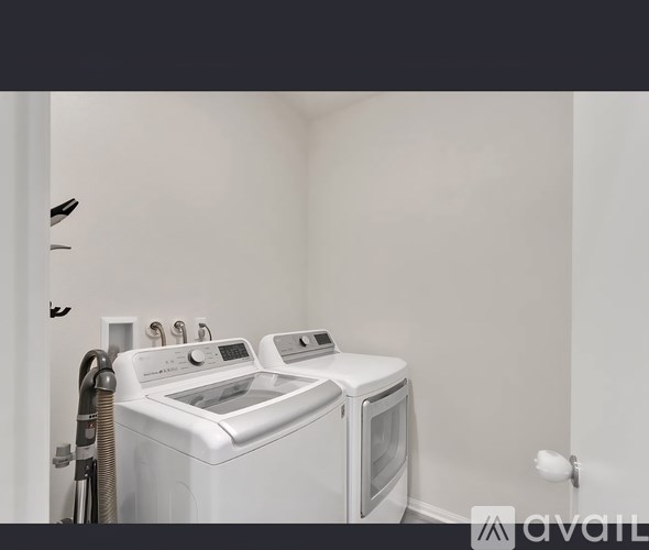 A white washing machine and dryer in a small laundry room.
