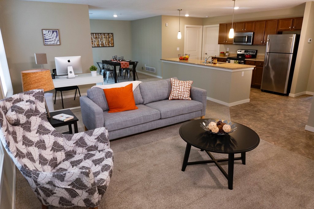 A living room with a grey couch and a black coffee table.