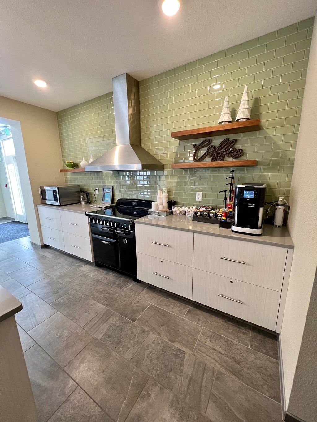 A kitchen with a coffee sign on the wall.