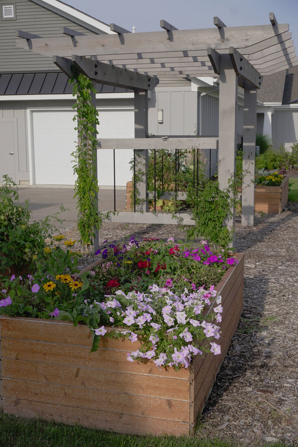 A wooden planter box filled with colorful flowers.