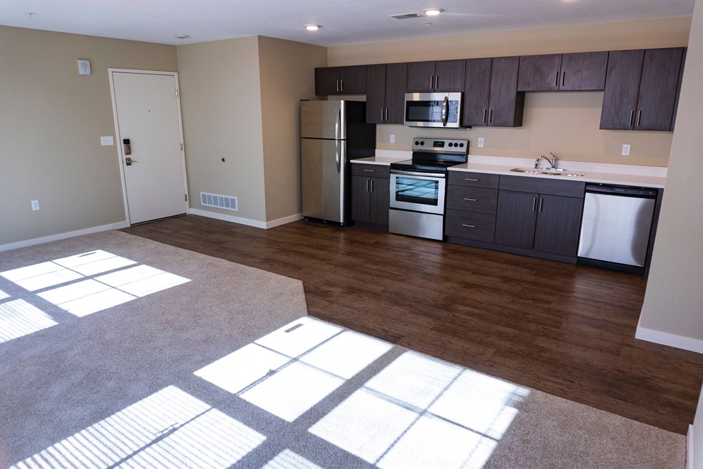 A kitchen with a refrigerator, stove, and oven.