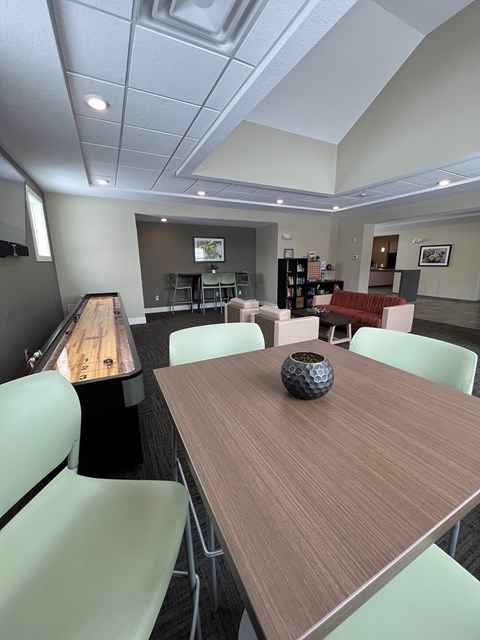 A conference room with a long table and chairs.