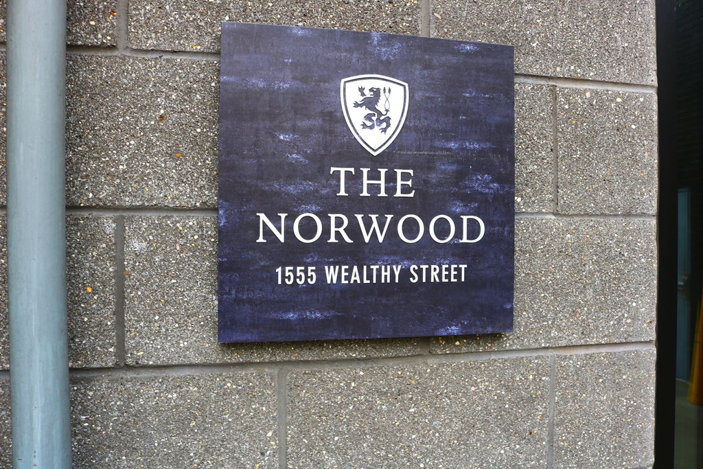 A sign for The Norwood is mounted on a wall.