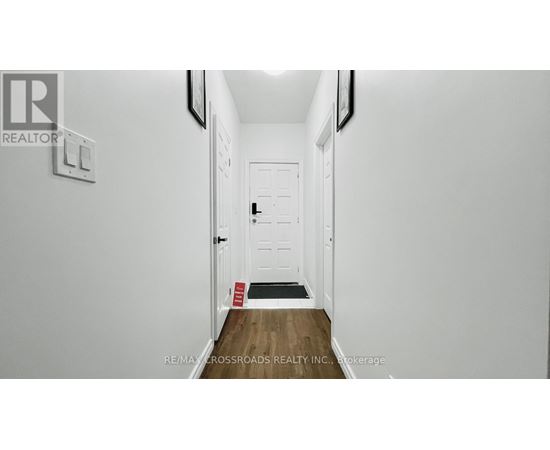 A hallway with a door and a sign on the wall.
