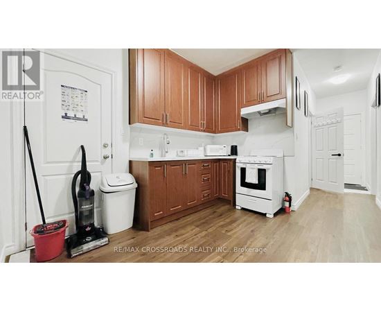 A kitchen with wooden cabinets and white appliances.